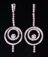 Lot 1215 - A pair of 14ct white gold and diamond set ear...