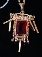 Lot 1220 - A Burmese 14ct gold and ruby set pendant, the...