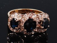 Lot 1233 - An 18ct gold, sapphire and diamond ring,...