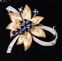 Lot 1240 - A modern 18ct gold, sapphire and diamond set...