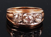 Lot 1252 - A 14ct gold diamond three stone ring, the...