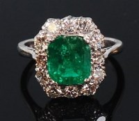 Lot 1274 - A platinum, emerald and diamond cluster ring,...
