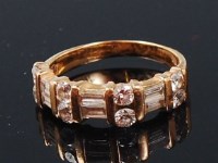 Lot 1283 - An 18ct gold diamond half eternity ring,...