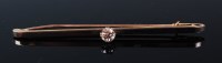 Lot 1302 - A yellow metal platinum faced diamond set bar...