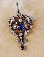 Lot 1303 - A circa 1900 yellow metal, sapphire and...