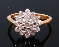 Lot 1306 - An 18ct gold diamond cluster ring, the tiered...