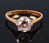 Lot 1307 - An 18ct gold diamond solitaire ring, the claw...