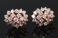 Lot 1145 - A pair of white gold and diamond cluster ear...