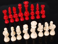 Lot 1358 - A turned ivory chess set, one side stained red,...