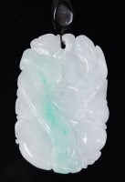 Lot 1378 - A Chinese carved celadon jade pendant, having...