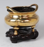 Lot 1381 - An 18th century Chinese bronze tripod censor,...