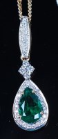 Lot 1218 - An 18ct gold, emerald and diamond set pendant,...