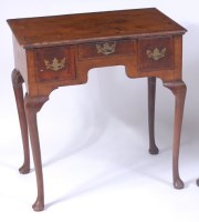 Lot 1504 - A George II walnut and figured walnut lowboy,...