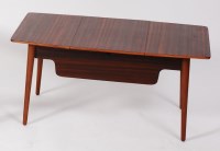 Lot 242 - A 1950s walnut low work table, having central...