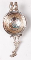 Lot 1163 - An Edwardian silver novelty tea strainer,...
