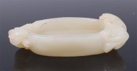Lot 1401 - A Chinese carved celadon jade shallow dish, of...