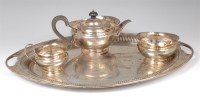 Lot 739 - An Edwardian silver three-piece teaset on twin...