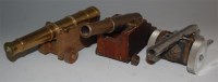 Lot 543 - A brass model of an artillery cannon on an oak...