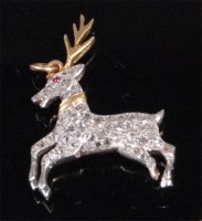 Lot 200 - A yellow gold and diamond set 'stag' pendant,...