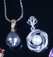 Lot 228 - A yellow gold grey pearl pendant, with small...