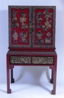 Lot 324 - A Chinese red lacquered cabinet on stand,...