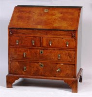 Lot 504 - An 18th century walnut slopefront writing...