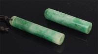 Lot 1430 - A Chinese polished jadeite cylindrical pendant,...