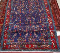 Lot 1574 - A Persian woollen blue ground rug, decorated...