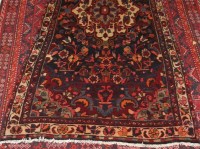 Lot 1580 - A Persian woollen rug, the medallion floral...