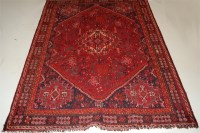 Lot 1581 - A Persian woollen Shiraz rug, the rust...