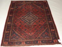 Lot 1582 - A Persian woollen rug, the rust coloured field...