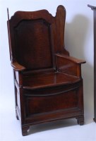 Lot 1618 - An antique joined oak lambing chair, having a...