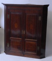 Lot 1619 - A George III oak hanging corner cupboard,...