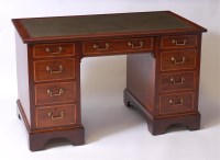 Lot 1658 - An Edwardian mahogany kneehole writing desk,...