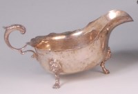 Lot 428 - A Georgian style silver sauceboat, raised on...