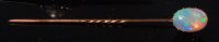 Lot 491 - A yellow metal opal set tie-pin, the cabochon...