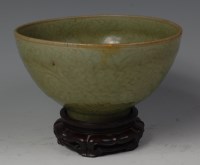 Lot 615 - A Chinese carved celadon bowl, probably Ming...