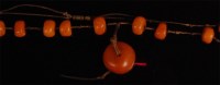 Lot 915 - A beaded butterscotch amber necklace, arranged...