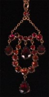 Lot 970 - An Edwardian yellow gold and garnet set...