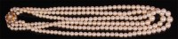 Lot 973 - A graduated cultured pearl triple string...