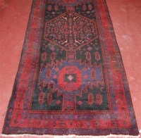 Lot 1272 - A Persian woollen rug, the triple medallion...