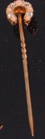 Lot 519 - A yellow metal horseshoe tie-pin, set with...