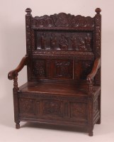 Lot 811 - An antique carved and joined oak highback...