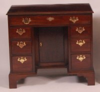Lot 829 - A mahogany kneehole desk, in the Georgian...