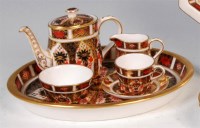 Lot 77 - A Royal Crown Derby miniature teaset,...