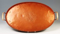 Lot 146 - An Arts & Crafts hammered cooper twin handled...