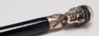 Lot 318 - A circa 1900 ebony walking cane, the handle in...