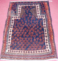 Lot 543 - A Persian woollen prayer rug, the blue ground...