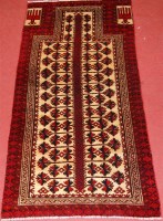 Lot 544 - A Persian woollen prayer rug, having a cream...