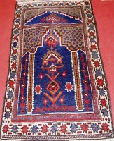 Lot 545 - A Persian woollen prayer rug, having a blue...